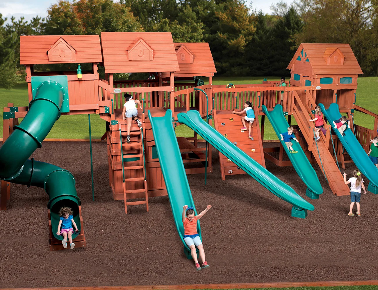 Children playing on a large wooden playground with multiple slides and climbing structures.