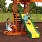 Child on the Super Safe Speedy Slide of the Sunnydale Cedar Swing Set, with the snack stand alongside