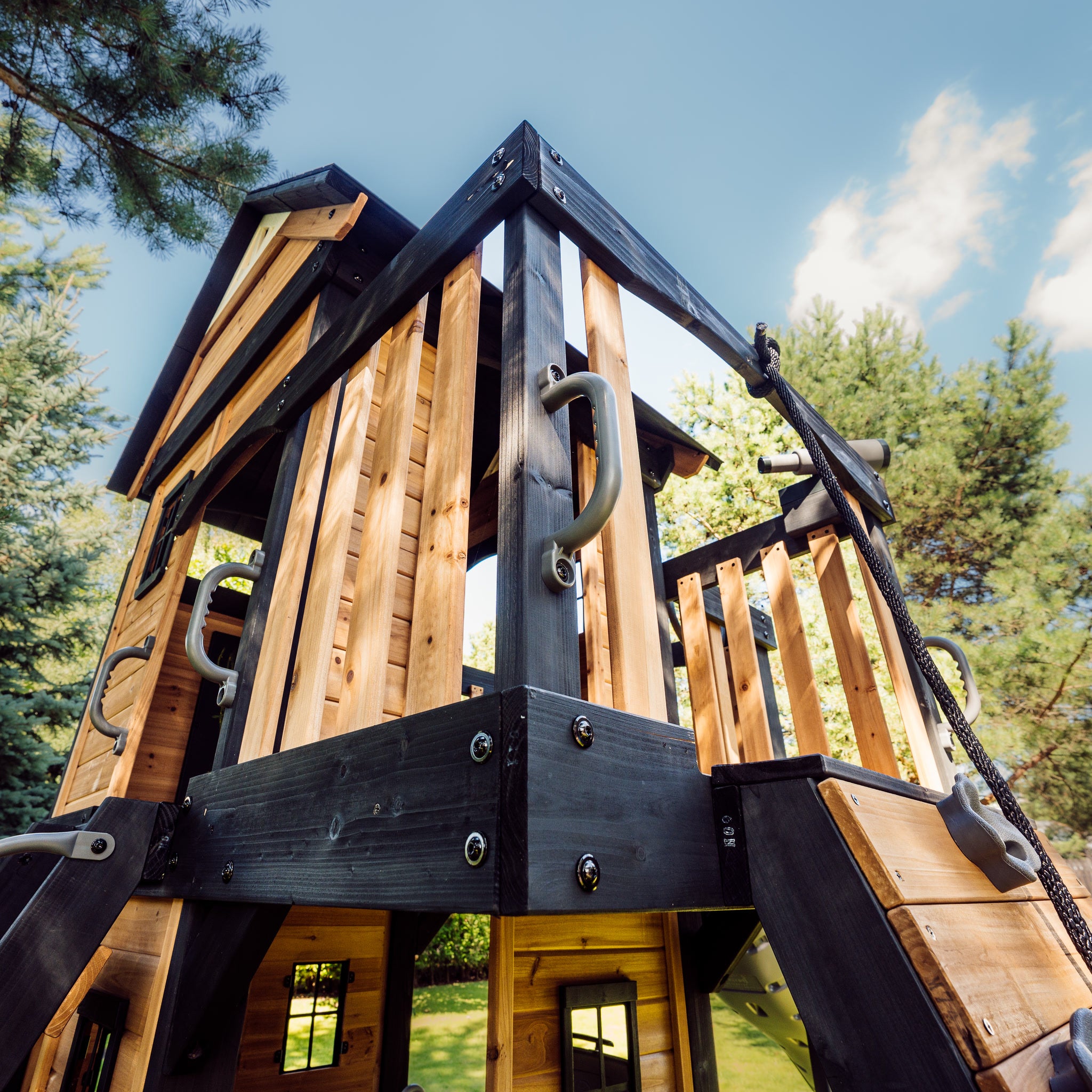 Canyon Creek upper fort seen from below, showing cedar cladding, charcoal framing and grab handles
