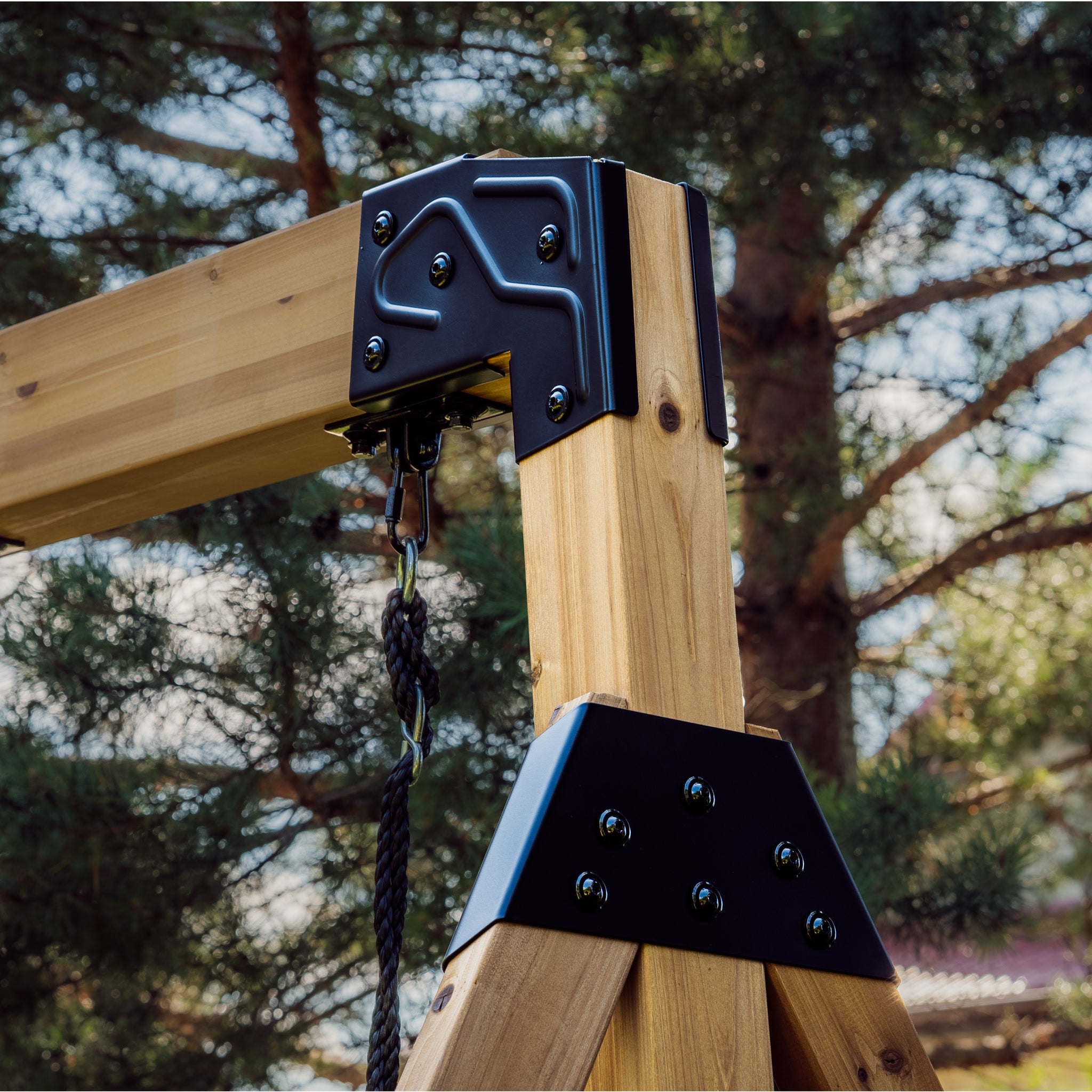 Powder-coated steel bracket joining the Canyon Creek swing beam to its A-frame legs